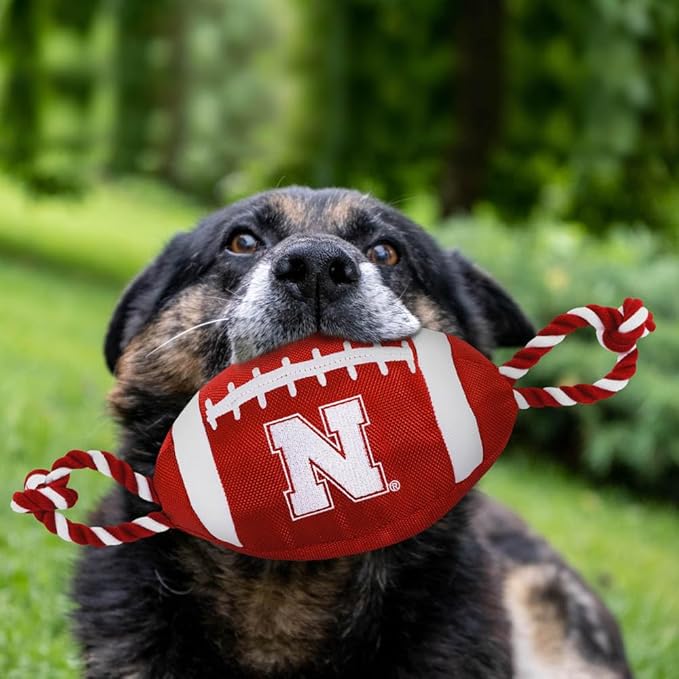 Pets First NCAA Nebraska Cornhuskers Football Dog Toy, Tough Quality Nylon Materials, Strong Pull Ropes, Inner Squeaker, Collegiate Team Color